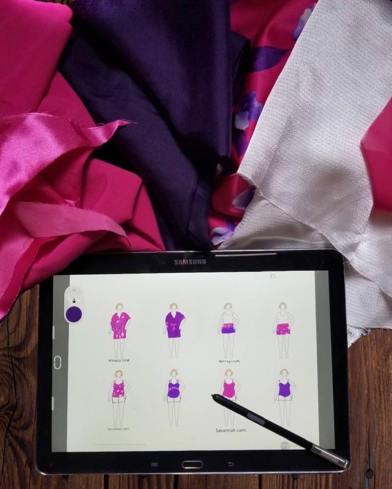 tablet flat lay of Pam's scrap busting lingerie sewing plans: digital fashion drawings on MyBodyModel croquis templates, surrounded by silky fabrics from her stash